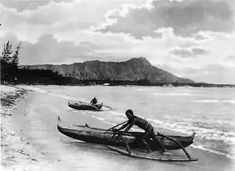 Polynesians with outrigger canoes at Waikiki Beach, Oahu Island, early 20th century