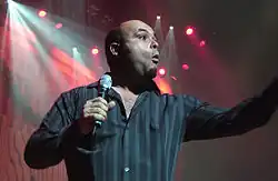 Tyler Stewart onstage, holding a microphone