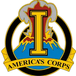 A gold device containing a gold letter I superimposed over an erupting volcano, with the words "America's Corps" at the bottom