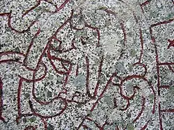 A female figure bearing a horn on runestone U 1163.