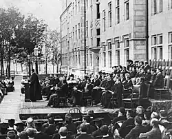 A professor addressing a crowd