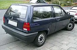 Rear-three quarter view of a small three-door car with flush headlamps.
