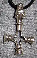 Replica of a silver pendant from the Viking period (c. 11th century) found in Foss, Iceland, sometimes described as "wolf cross" (vargkors). It could be interpreted both as a Christian cross and as a Heathen Thor's hammer (Mjolnir or Mjöllnir).