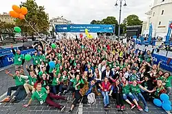 A large group of young people in green T-shirts