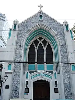 A church exterior that is gray and teal (Central United Methodist Church)