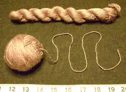 Transformation of a hank of lavender silk yarn (top) into a ball in which the knitting yarn emerges from the center (bottom). The latter is better for knitting, since the yarn is much less likely to tangle.