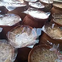 Sweet yogurt, made and contained in pots of clay are kept for sale, Bangladesh.