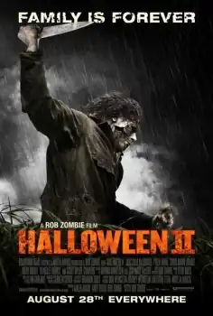 In a field of tallgrass on a rainy day, Michael Myers, with a withered mask, holds an unseen person's hair in one hand and holds up a knife in the other.