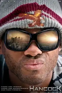 A closeup of Will Smith (as John Hancock) looking out towards the Los Angeles Skyline. His goggles show a reflection of the city with the sun setting. The film's tagline reads "THERE ARE HEROES. THERE ARE SUPERHEROES. AND THEN THERE's... HANCOCK"