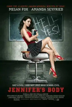 Jennifer holding books in her arms sitting on a school desk, wearing a red top and short plaid skirt, in front of a blackboard with the words HELL YES! written in chalk. A hand can be seen trapped by the lid of the school desk. The poster bears the tagline "She's evil ... and not just high school evil" in white block capital letters, with the film title underneath in large red block capital letters.