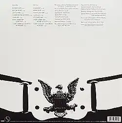 An image that is primarily black and white (monochrome) photo which consists of small writing on the upper side and a bald eagle belt buckle on the bottom side.
