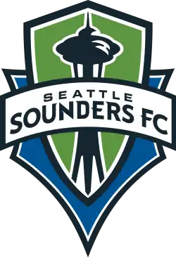 The Seattle Sounders FC crest, with the team's name on a banner stretched across a green and blue shield with the shape of the Space Needle in the center.