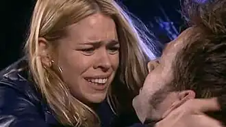 Rose Tyler (Billie Piper) cradles a dying Doctor (David Tennant) after he has been shot by a Dalek extermination ray.