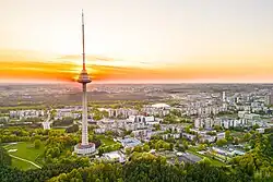 Very tall transmission tower, surrounded by smaller buildings